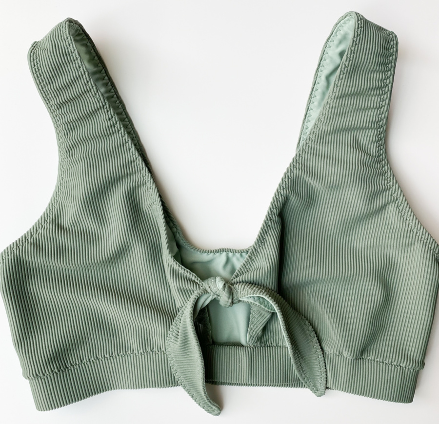 Vernazza swim suit top in ribbed tricot fron Sitka Fabrics in the colour Sage. Flat lay front view.