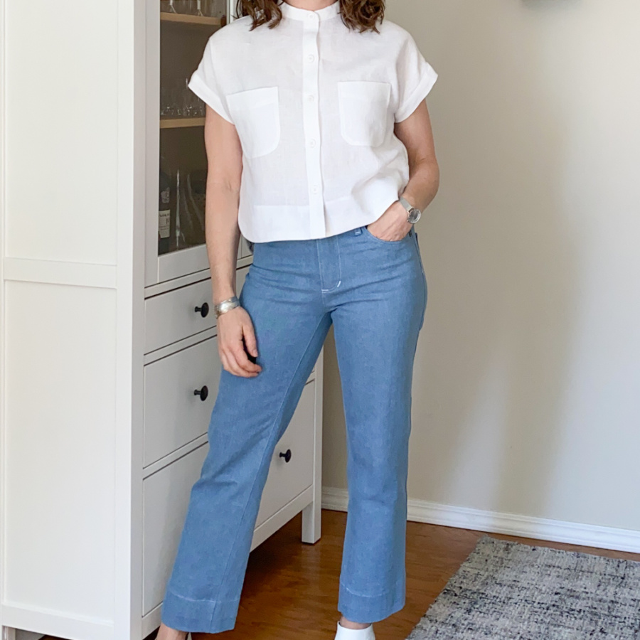 White linen Kalle Shirt worn with light blue Ginger jeans, front view.