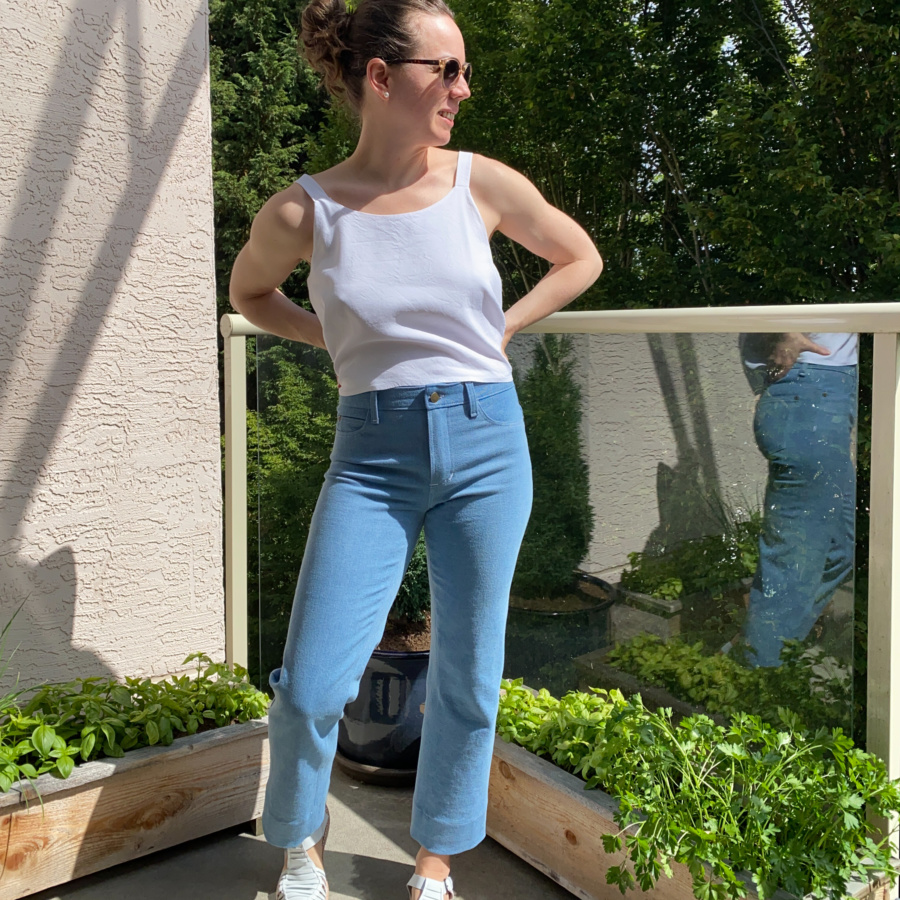 White modified ogden cami and wide leg, light wash ginger jeans, front view