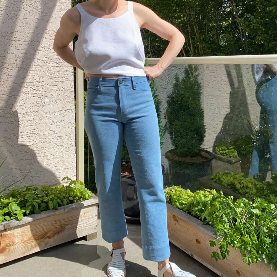 White modified ogden cami and wide leg, light wash ginger jeans, front view