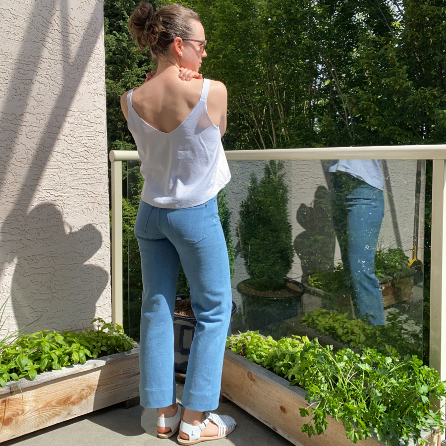 white modified Ogden cami and wide leg, light wash ginger jeans, back view