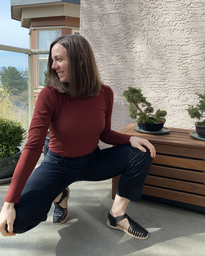Me, crouching, wearing Astrid sandals, black jeans and rust coloured turtleneck