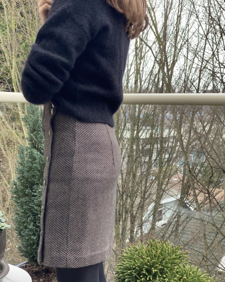 Side view of the wool skirt showing the edge of the left side opening.