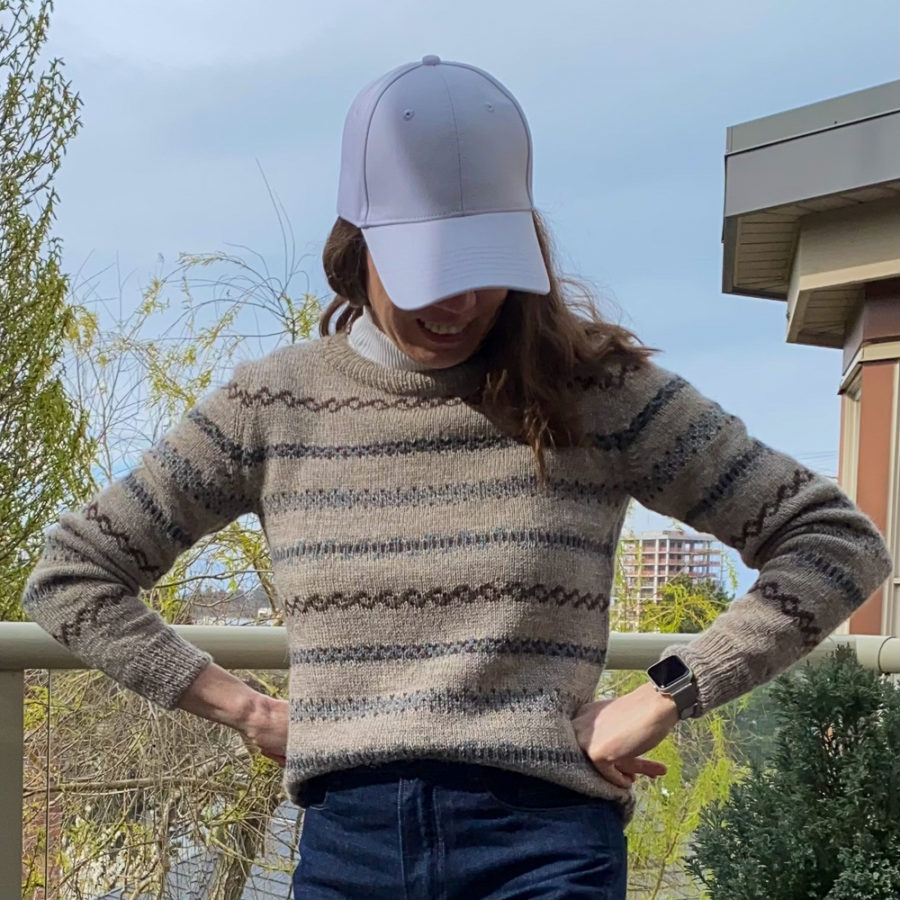 Ashland sweater front view, worn with white turtleneck, white ball cap and blue jeans.