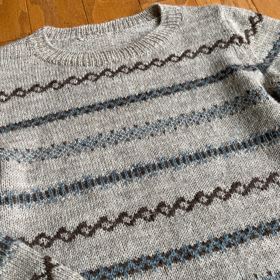 Close up of the front of the Ashland sweater showing the coloured bands.